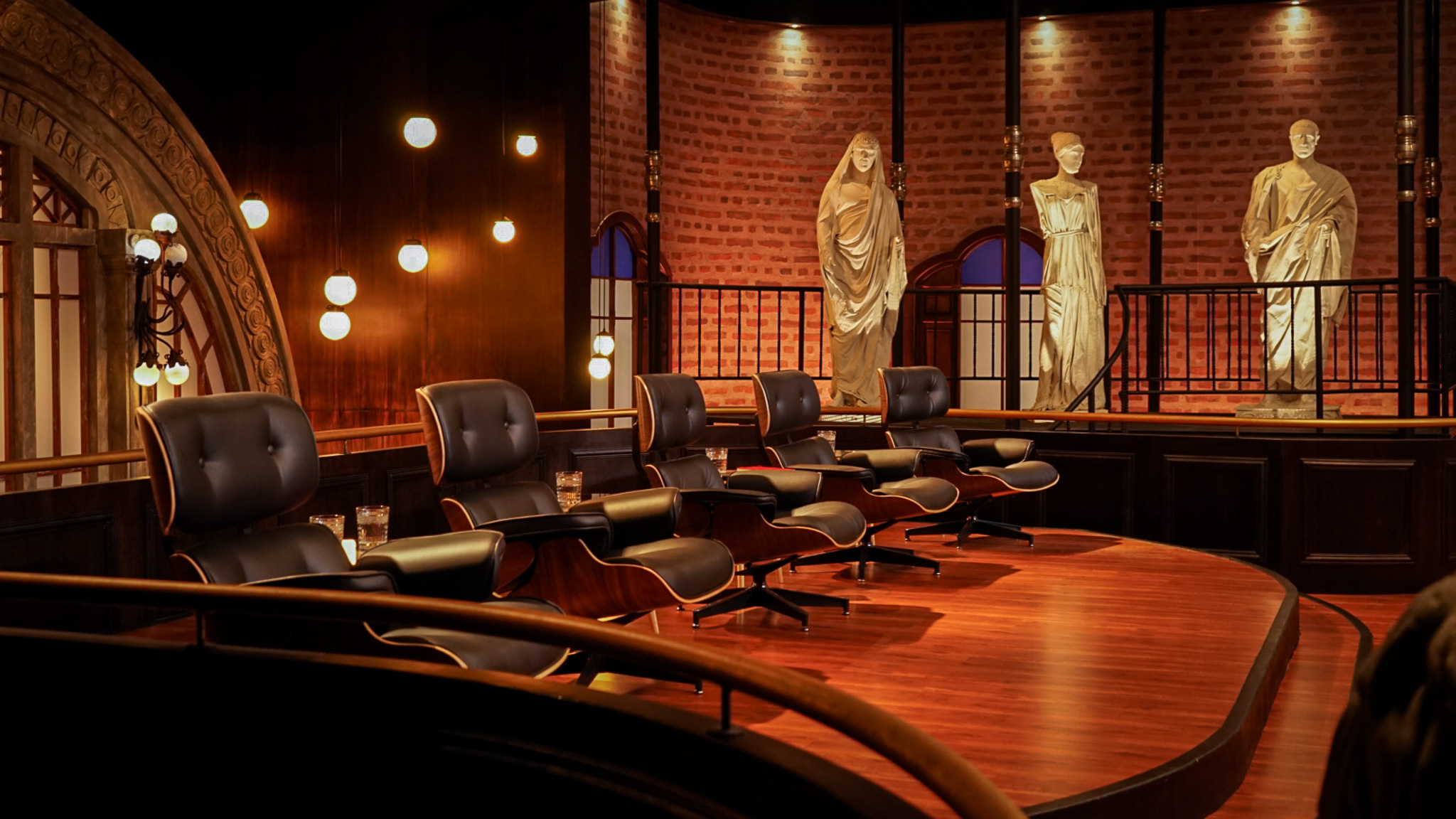 Shark Tank set — Eames chairs and statues